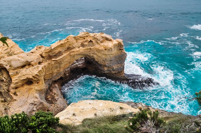 Natural Rock Arch Over Ocean Waves Along Rugged Coastline - Download Free Stock Photos Pikwizard.com