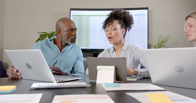 Diverse Team Analyzing Data on Laptops and Tablet in Office Meeting - Download Free Stock Images Pikwizard.com