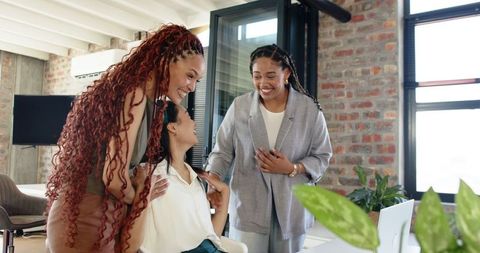 Diverse Female Colleagues Collaborating Joyfully in Modern Office