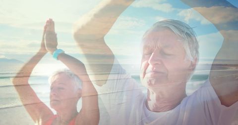 Senior Couple Practicing Yoga By Seaside with Glowing Light Overlay