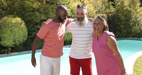 Senior Friends Embracing Enjoyment by Swimming Pool