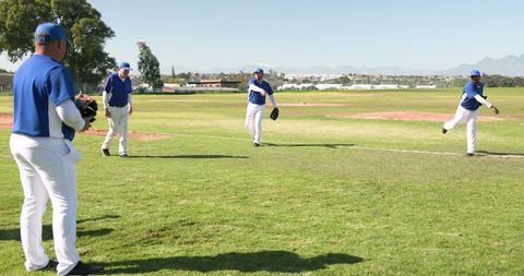 Baseball Team Practicing on Sunny Field for Teamwork and Athleticism