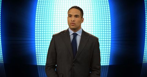 Confident businessman in suit with digital futuristic background