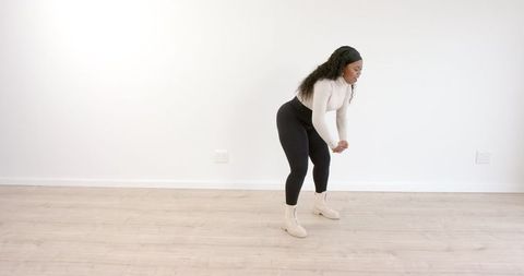 Woman Stretching Indoors in Activewear for Exercise Preparation