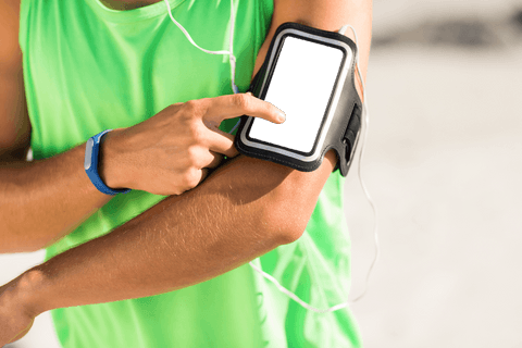 Man Using Smartphone with Armband at Sunny Beach for Workout - Download Free Stock Videos Pikwizard.com