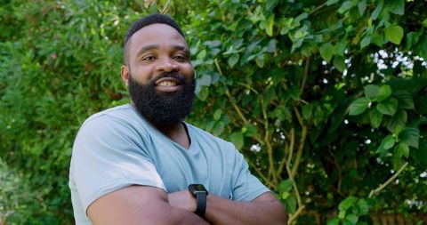 Confident Man Relaxing in Lush Green Garden