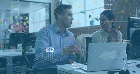 Colleagues Collaborating Over Data Visualization on Laptop with Augmented Reality Overlay