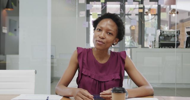 Confident Businesswoman Sitting in Modern Office Setting - Download Free Stock Images Pikwizard.com