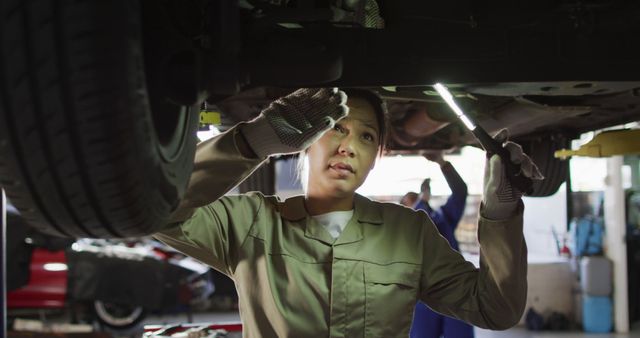 Female Mechanic Working Under Vehicle in Auto Repair Shop - Download Free Stock Images Pikwizard.com