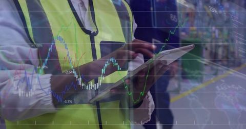 Factory supervisor using tablet with analytics overlay for real-time production monitoring