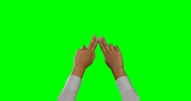Hands in a steeple gesture against a green screen background, with copy space. Such a gesture is often associated with confidence or contemplation.