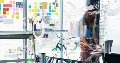 Innovative Businesswoman Analyzing Financial Data in Modern Office