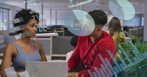 Professional team analyzing digital data in modern office environment
