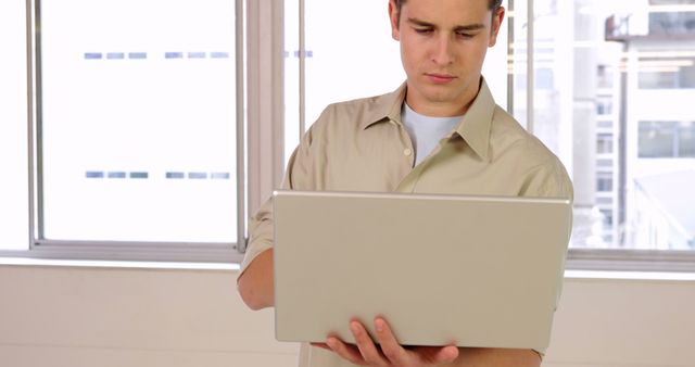 Focused Adult Male Working on Laptop in Modern Office - Download Free Stock Images Pikwizard.com