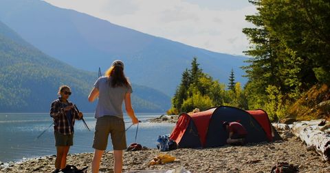 Campers Enjoying Lakeside Adventure Amidst Serene Mountain Scenery