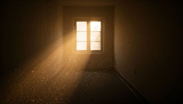 Golden Sunbeams Streaming Through Paneled Window Into Dusty Empty Room at Sunrise