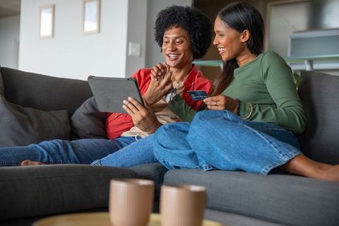 Happy Couple Online Shopping Together in Cozy Living Room