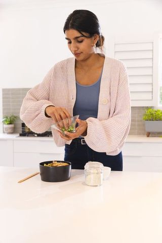 Indian Woman Preparing Healthy Meal at Home in Modern Kitchen