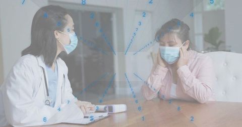 Doctor consulting masked patient at table with infrared thermometer and data overlay