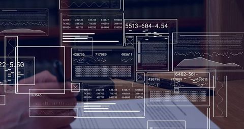 Business analyst holding pen over report with data overlays and analytics dashboard