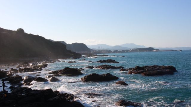 Rocky Coastline with Crashing Waves and Distant Mountains - Download Free Stock Photos Pikwizard.com