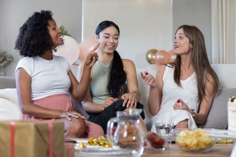 Diverse female friends celebrating with conversation and treats