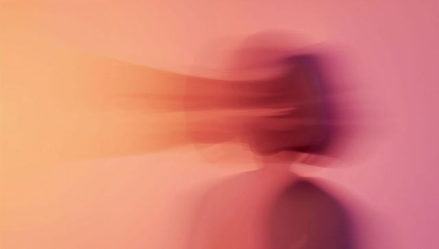 Ethereal motion-blur silhouette in warm pink-orange duotone gradient for concept art
