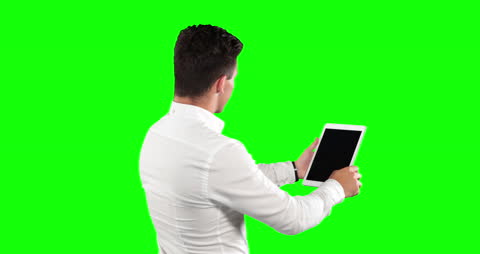 Businessman Using Tablet on Green Background
