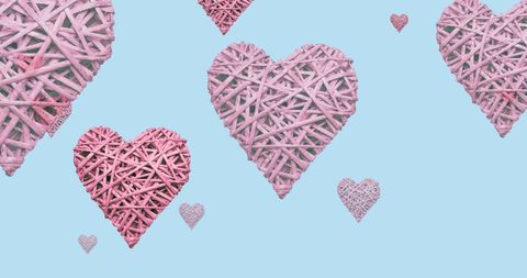 Pink woven hearts on blue for breast cancer awareness