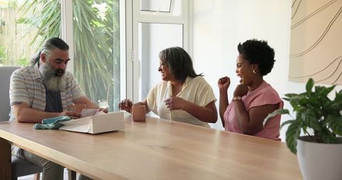 Senior Couple Enjoying Family Time Sharing Gifts at Home