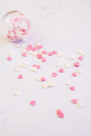 Pastel Heart Sprinkles Spilling from Open Jar