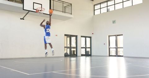 Athletic African American Man Shooting Basketball Indoors