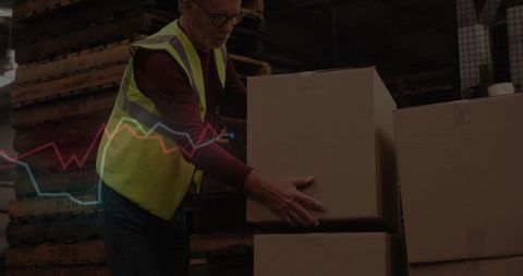Warehouse worker lifting boxes with safety vest