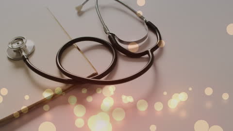 Stethoscope and Notebook with Abstract Light Spots Overlay
