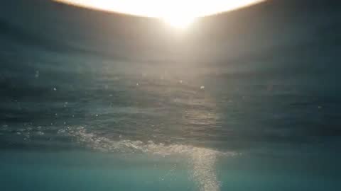 Underwater Sunrise Glow with Floating Bubbles and Light Refraction