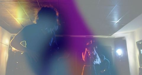 Vibrant Live Music Performance: Musicians on Stage with Colorful Lights