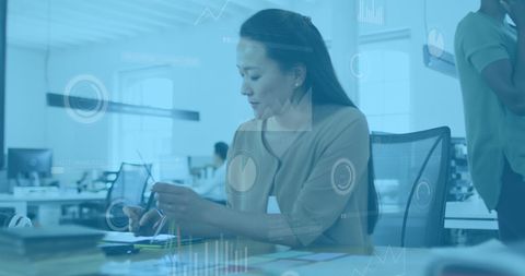 Asian Businesswoman Analyzing Innovative Digital Data in Modern Office