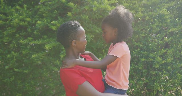 Mother Holding Daughter in Park Embracing Outdoors - Download Free Stock Images Pikwizard.com