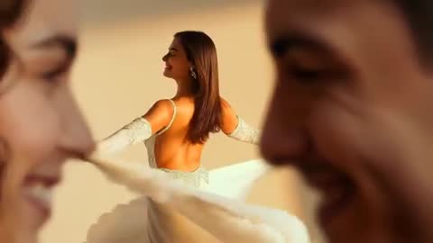 Couple Blurring Foreground Revealing Dancer Twirling Backless Gown in Golden Light