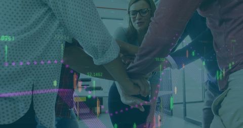 Diverse Colleagues Stacking Hands with Financial Data Overlay