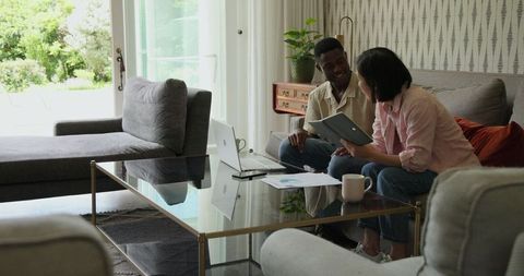 Couple planning wedding in cozy living room setting