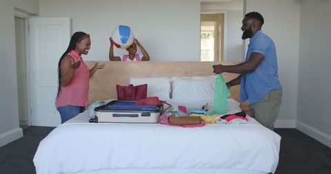 Family Joyfully Packing for Exciting Vacation Adventure