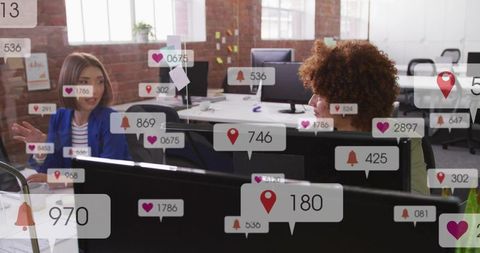 Team collaborating over social media notifications and engagement metrics in modern office