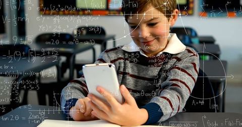 Young Boy Engaging with Digital Learning in Classroom