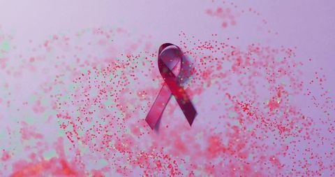 Breast Cancer Awareness Ribbon with Confetti on Purple Background