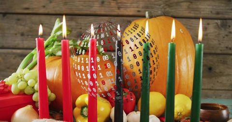 Digital Harvest glowing pumpkin center with lit red black green candles and floating binary globe