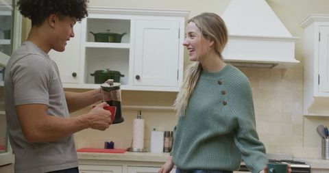 Diverse Couple Enjoying Coffee Together in Cozy Home Kitchen