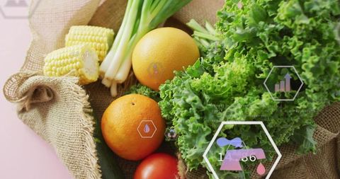 Featuring curly kale, oranges and corn on burlap with digital hud nutrition graphics