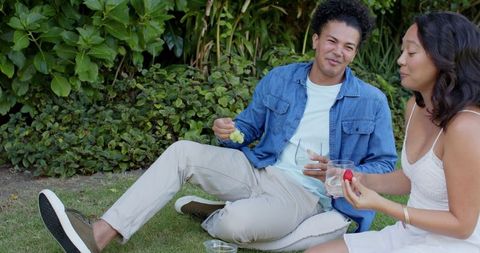 Couple Laughing and Relaxing Outdoors on Sunny Day