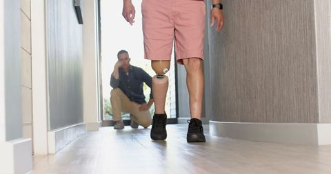 Therapist assisting patient with prosthetic leg mobility exercise